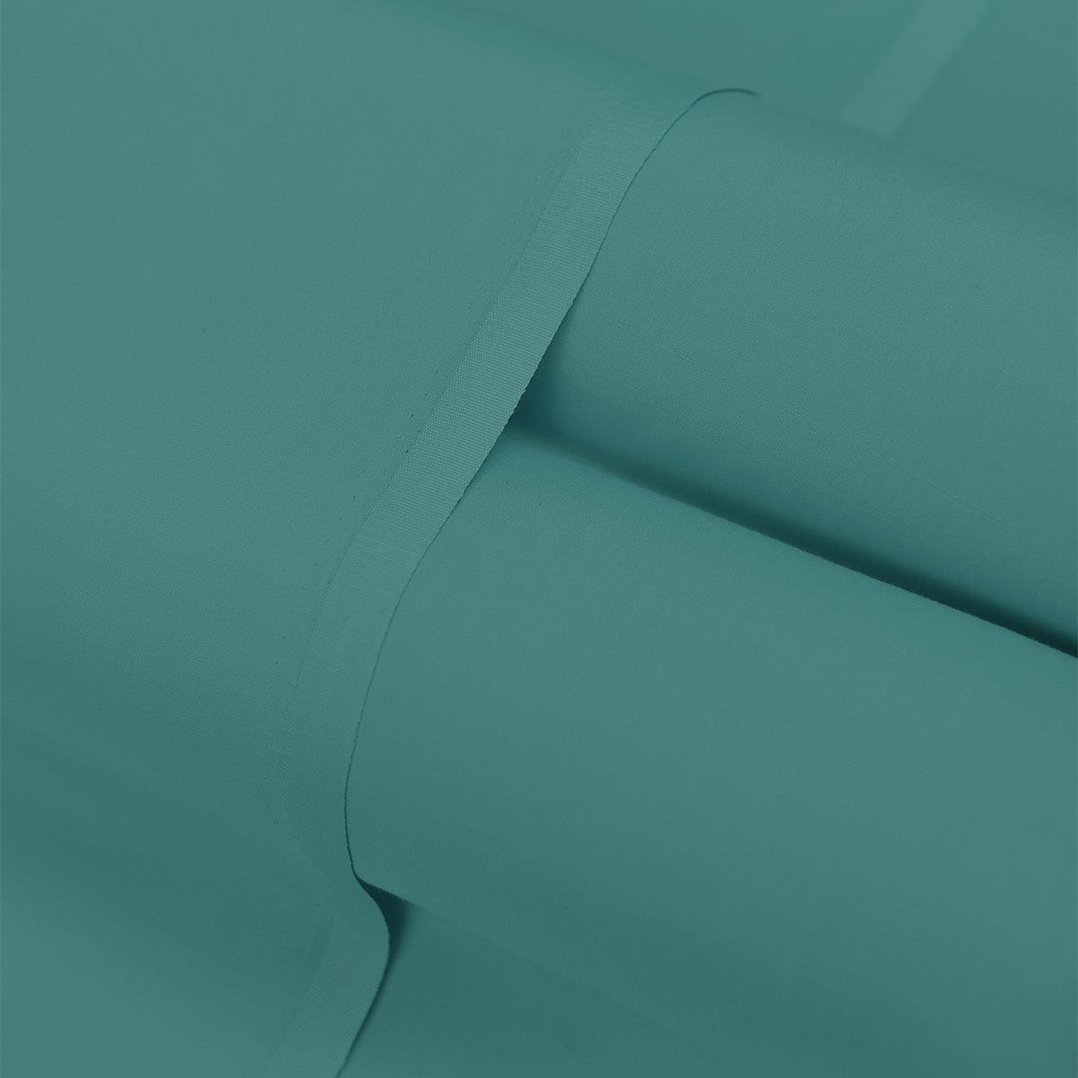 Teal fabric with a slight texture and fold on a matching background