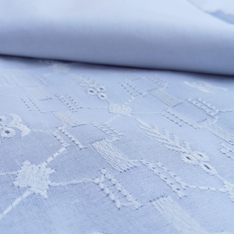Light blue fabric with white lace pattern