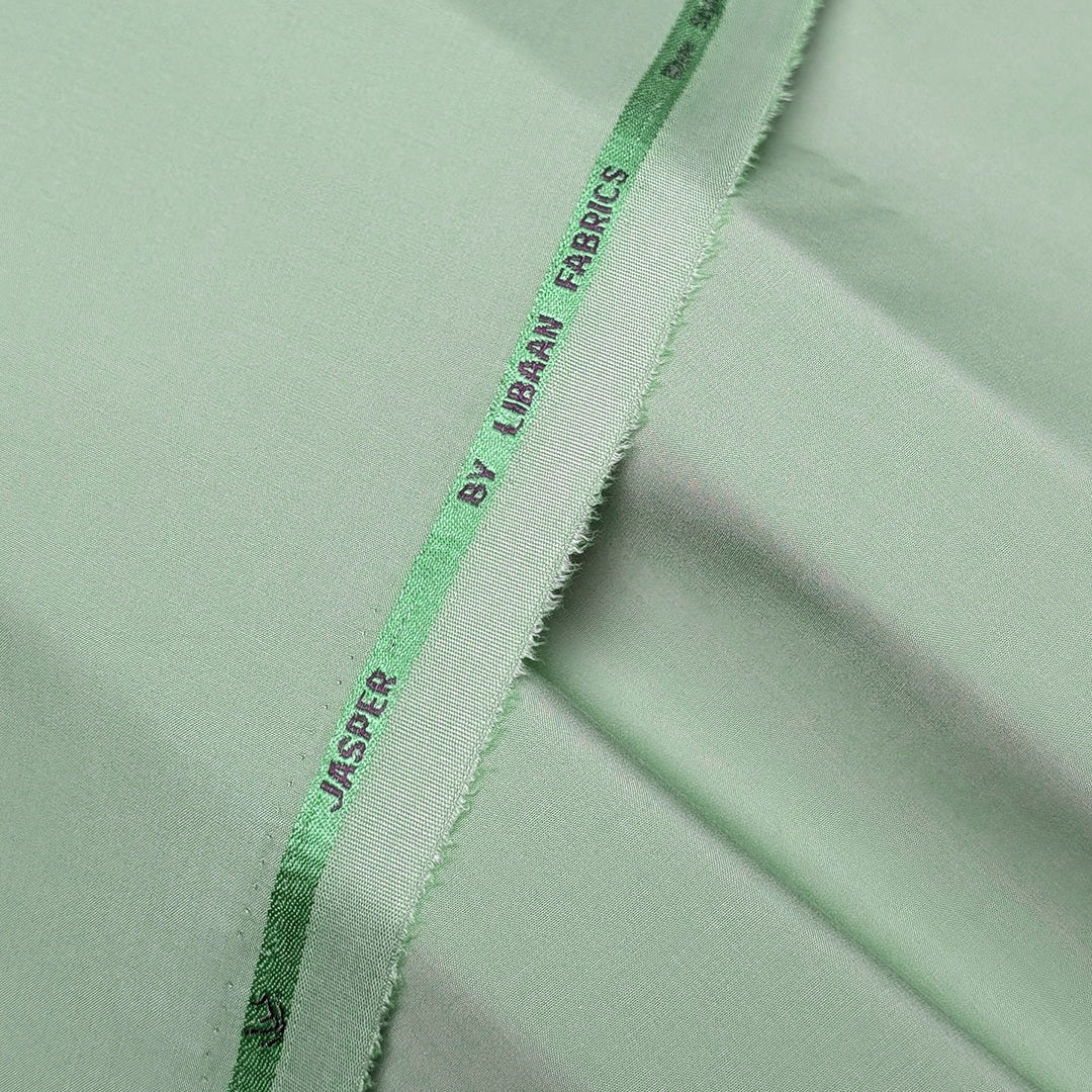 Close-up of green fabric with 'Jasper by Libbey Fabrics' label.