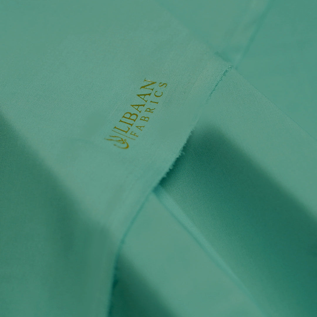 Teal fabric with 'Libaán Fabrics' logo in gold.