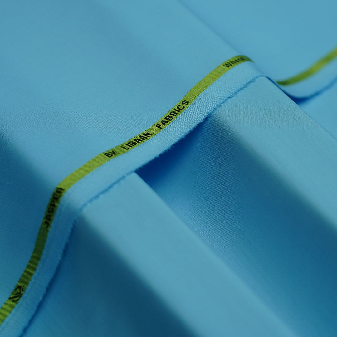 Close-up of a blue fabric with a yellow label on a blue background