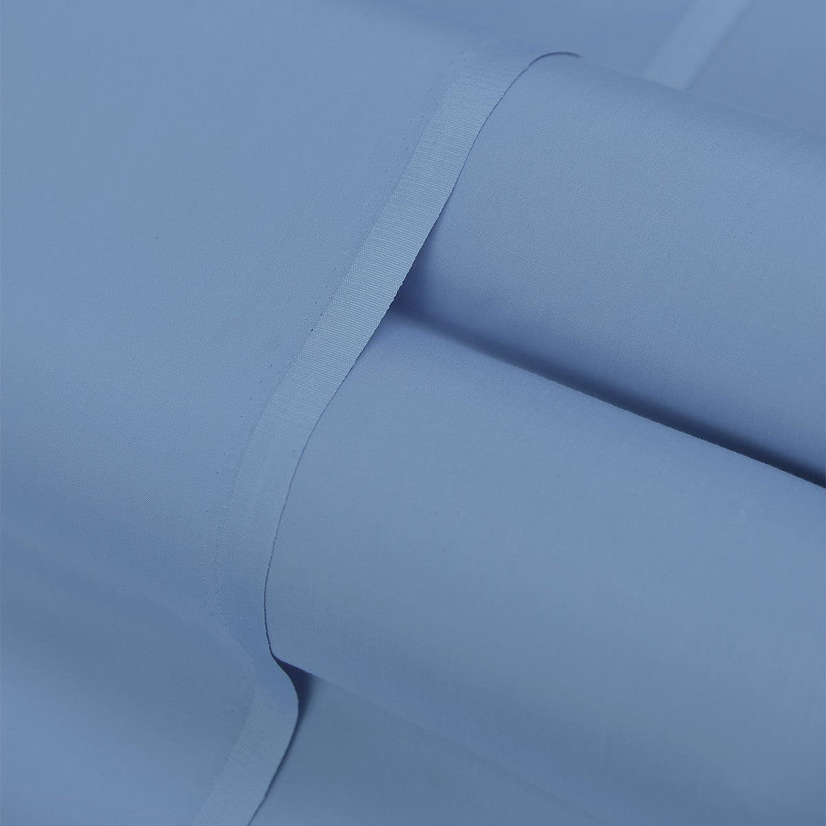 Close-up of a roll of blue paper with a visible crease.