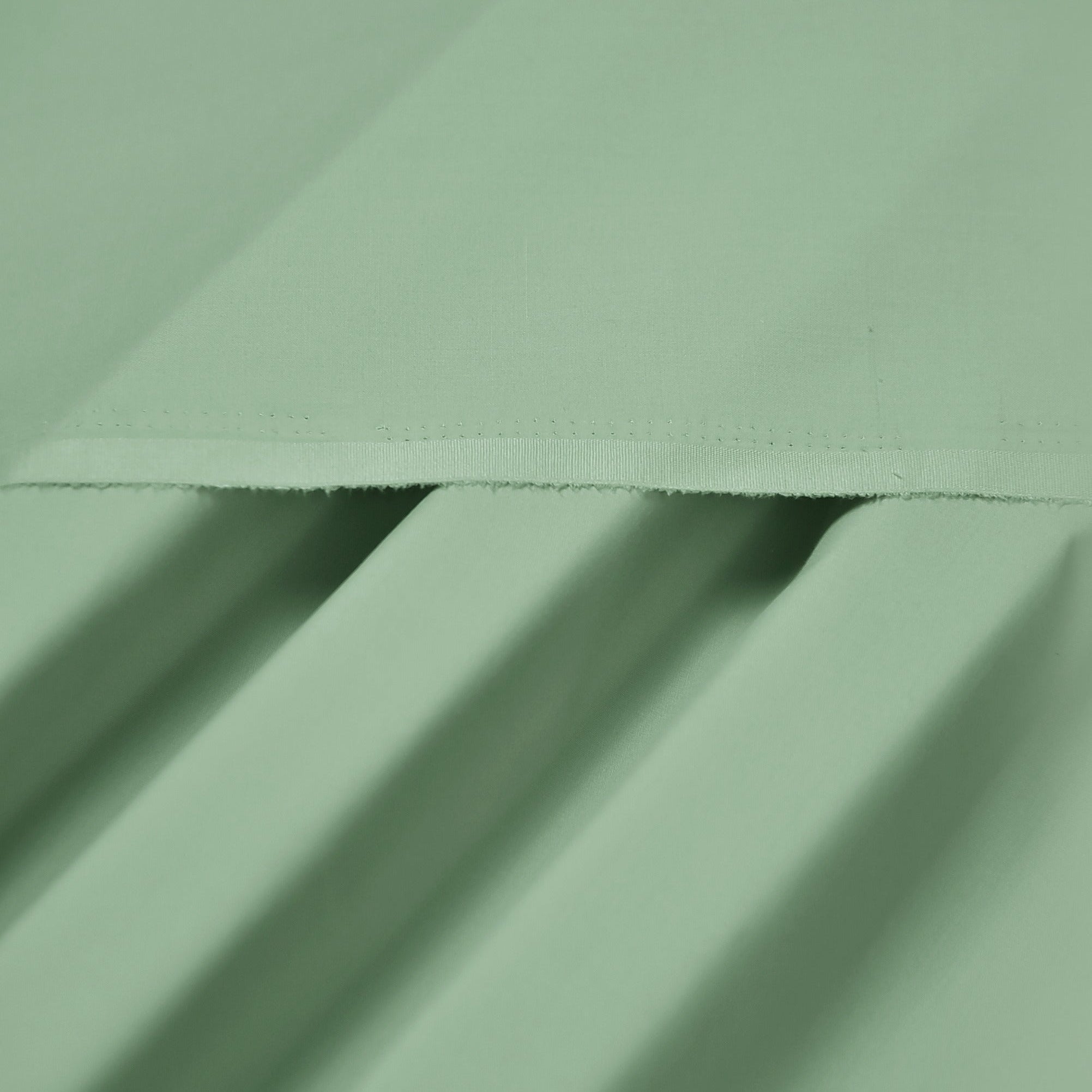 Close-up of light green fabric with folds