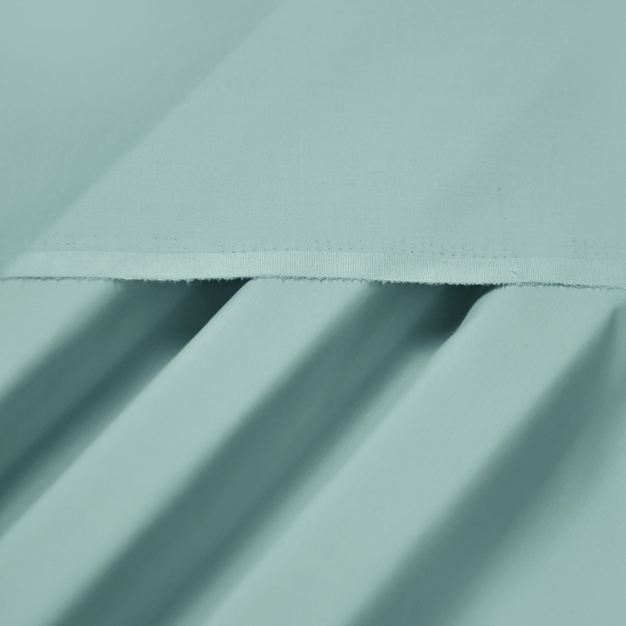 Close-up of light blue fabric with folds