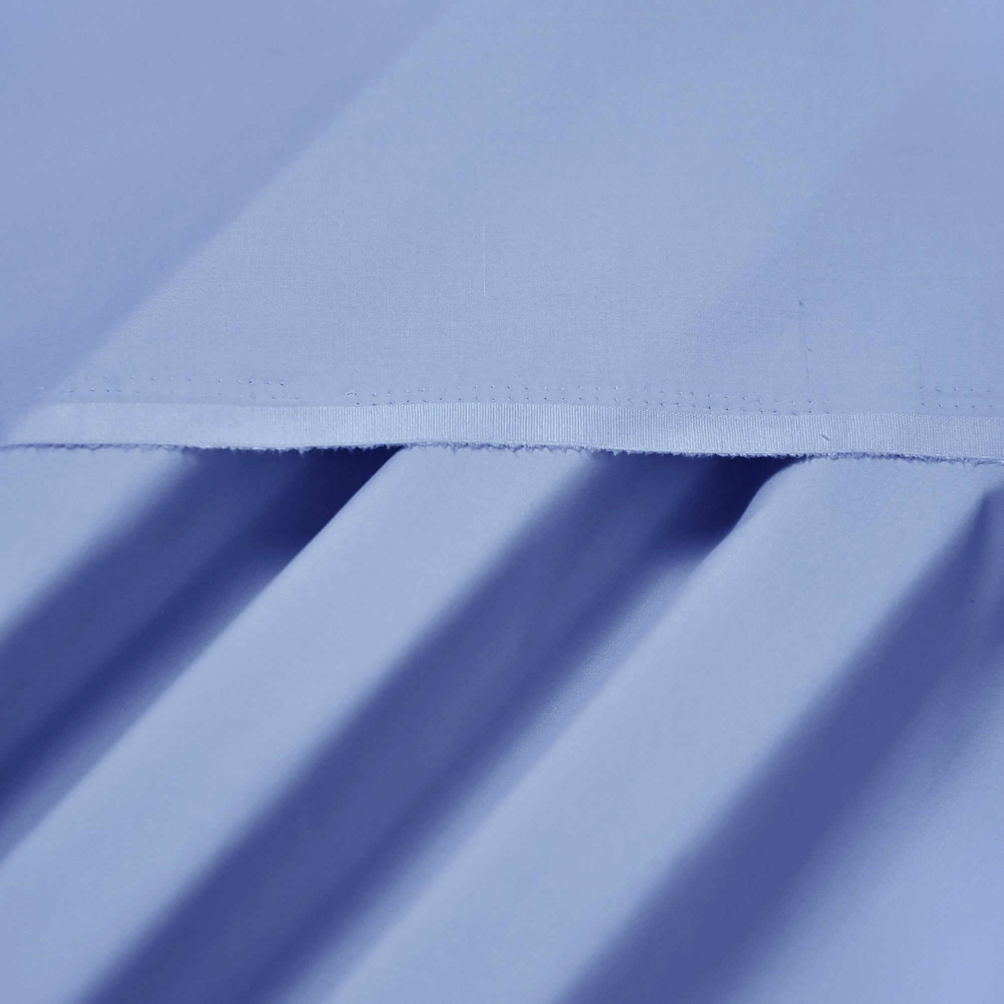 Close-up of light blue fabric with a subtle pattern