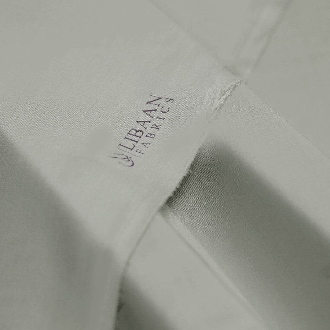 Close-up of Libaan Fabrics logo on a fabric surface