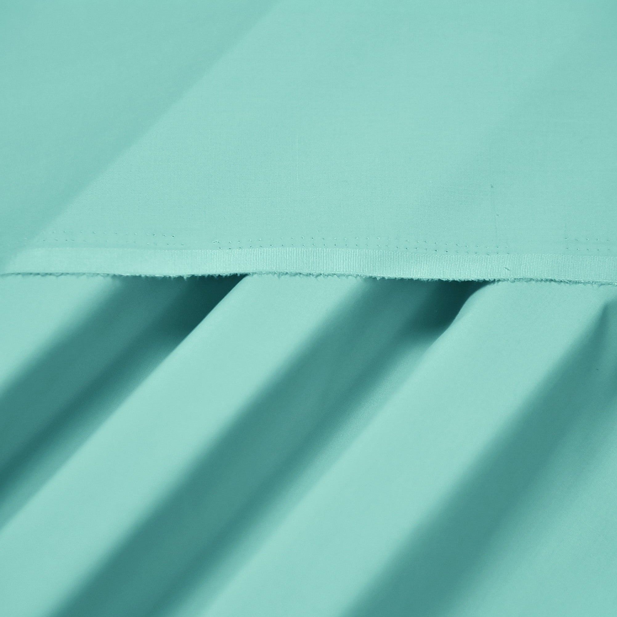 Close-up of teal fabric with folds